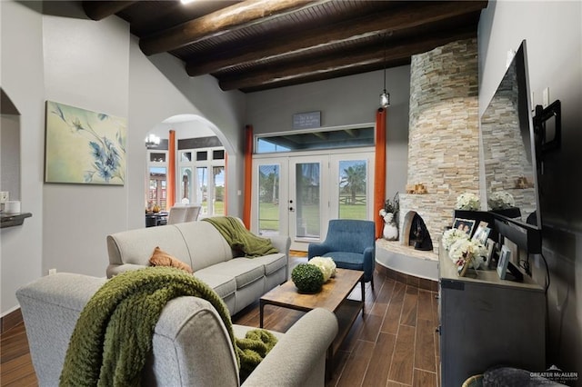 living room featuring french doors, beamed ceiling, and wood ceiling