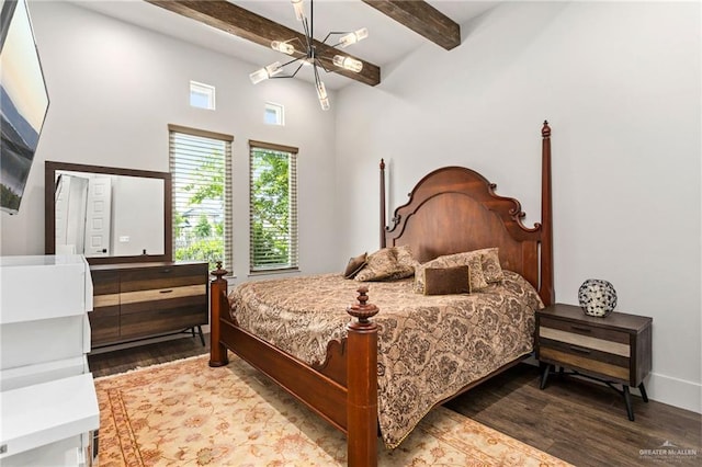 bedroom featuring hardwood / wood-style floors, beamed ceiling, a chandelier, and a high ceiling