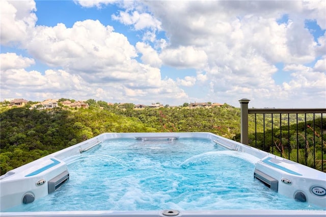 view of swimming pool featuring a hot tub