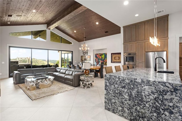 tiled living room with wooden ceiling, high vaulted ceiling, sink, beamed ceiling, and a notable chandelier