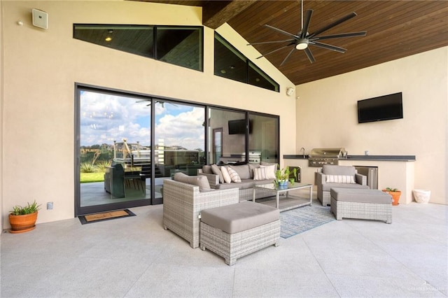 view of patio / terrace featuring area for grilling, an outdoor hangout area, an outdoor kitchen, and ceiling fan