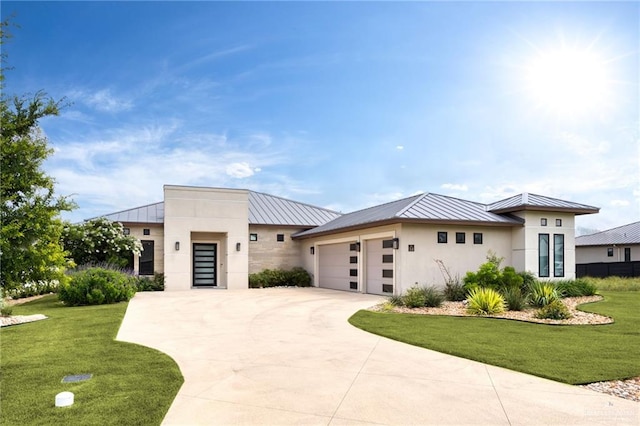 view of front of property with a front yard and a garage