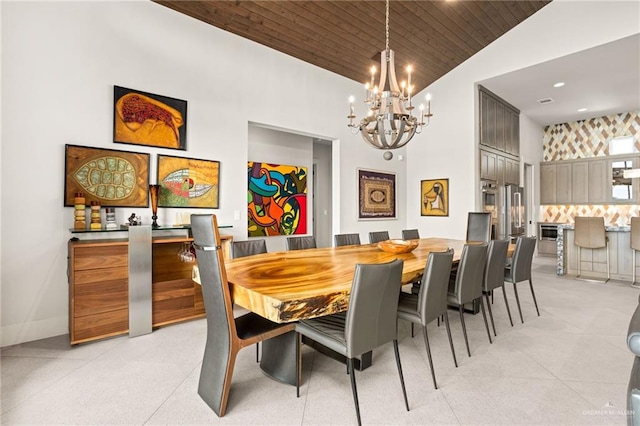 dining area with a notable chandelier, wood ceiling, and high vaulted ceiling