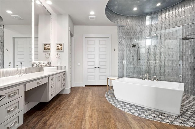 bathroom with vanity, shower with separate bathtub, and hardwood / wood-style flooring