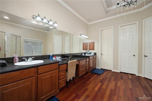 bathroom with hardwood / wood-style floors, a notable chandelier, an enclosed shower, and crown molding