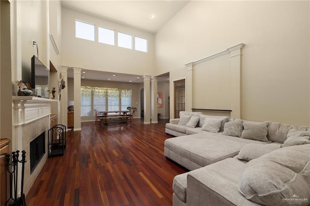 living room with dark hardwood / wood-style floors and high vaulted ceiling