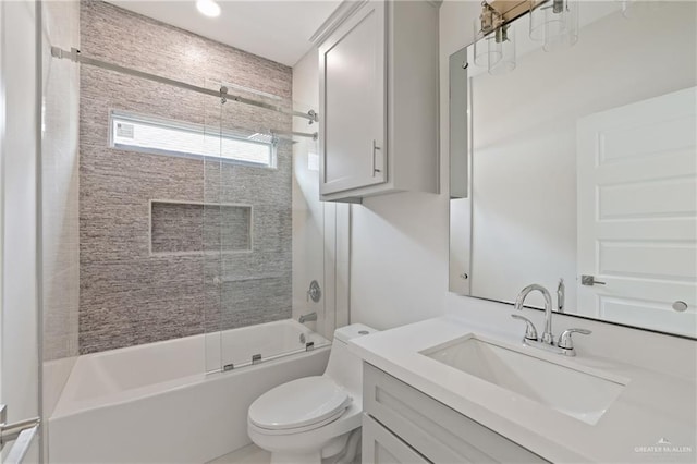 bathroom with vanity, combined bath / shower with glass door, and toilet