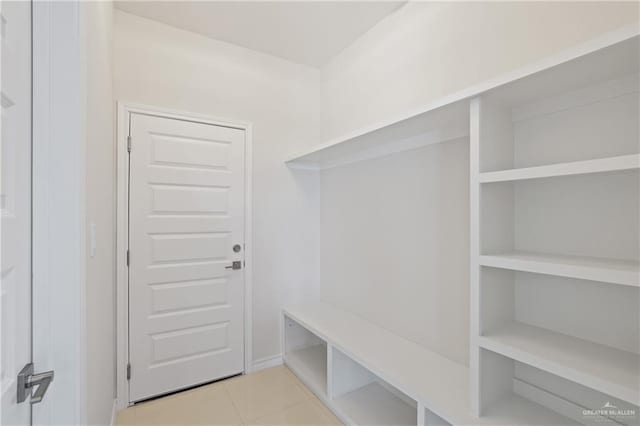 mudroom with light tile patterned floors and baseboards