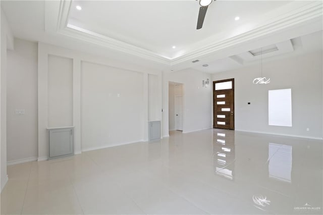 interior space featuring baseboards, a ceiling fan, light tile patterned flooring, and a tray ceiling