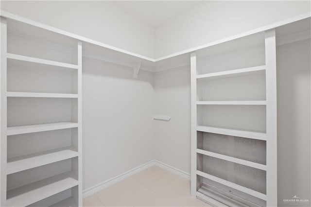walk in closet with tile patterned flooring