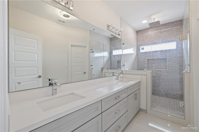 full bath featuring double vanity, visible vents, a shower stall, and a sink