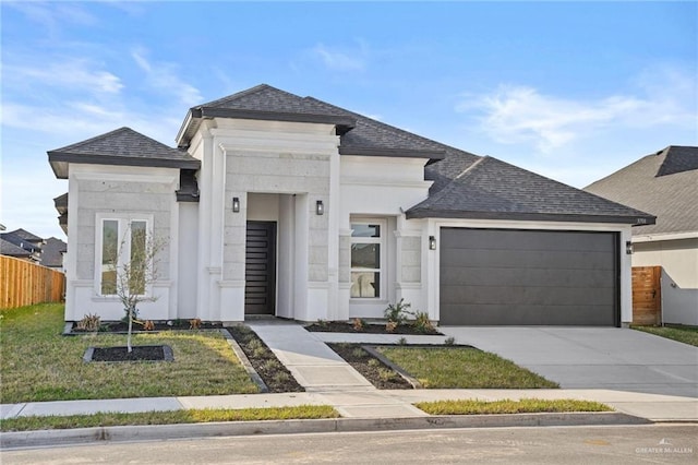 view of front of property featuring a garage, driveway, a shingled roof, and fence