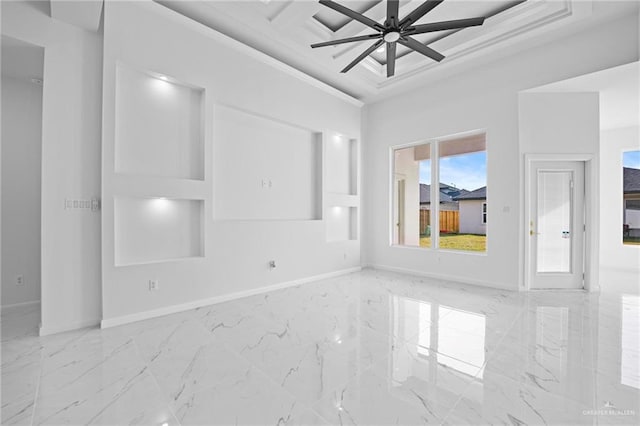 spare room with ceiling fan, marble finish floor, and baseboards