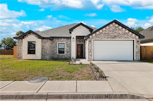 view of front of home featuring concrete driveway, an attached garage, fence, a front lawn, and brick siding