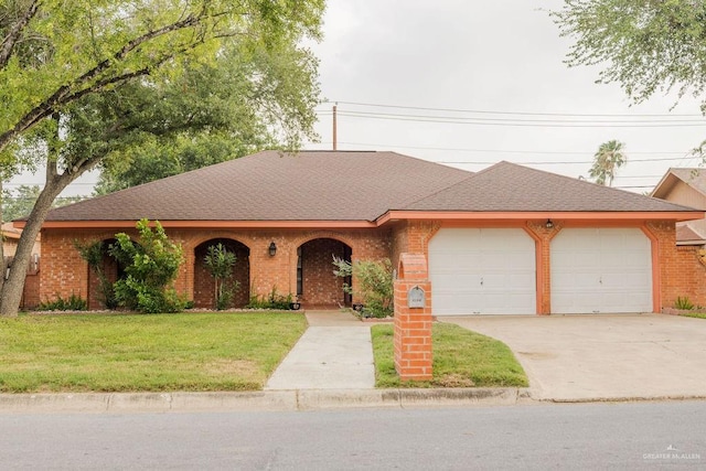 3208 Kiwi Ave, Mcallen, TX 78504 - view of front of property with a garage, brick siding, concrete driveway, a front lawn, and roof with shingles