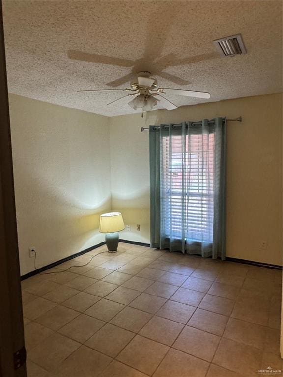 3208 Kiwi Ave, Mcallen, TX 78504 - empty room featuring a ceiling fan, light tile patterned flooring, baseboards, and a textured ceiling