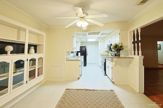 3208 Kiwi Ave, Mcallen, TX 78504 - kitchen with electric range oven, freestanding refrigerator, ceiling fan, white cabinets, and a textured ceiling