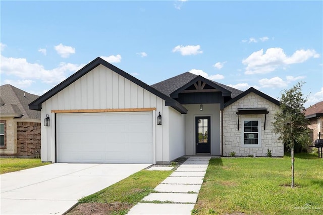 view of front of house with a front yard and a garage