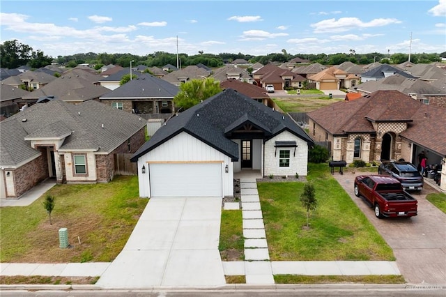 view of front of property featuring a garage and a front lawn