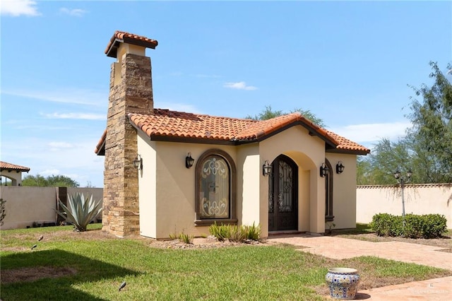 mediterranean / spanish-style house featuring a front lawn