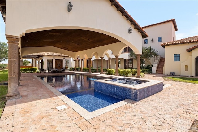 view of pool with an in ground hot tub and a patio area