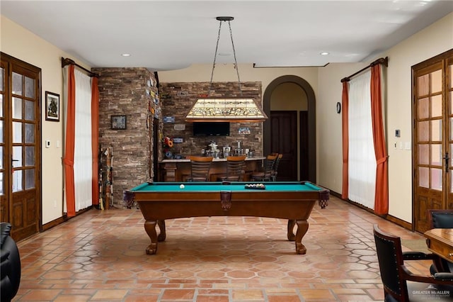 rec room with a wealth of natural light, billiards, and bar area