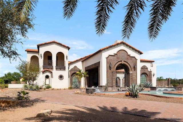 mediterranean / spanish-style home featuring a balcony