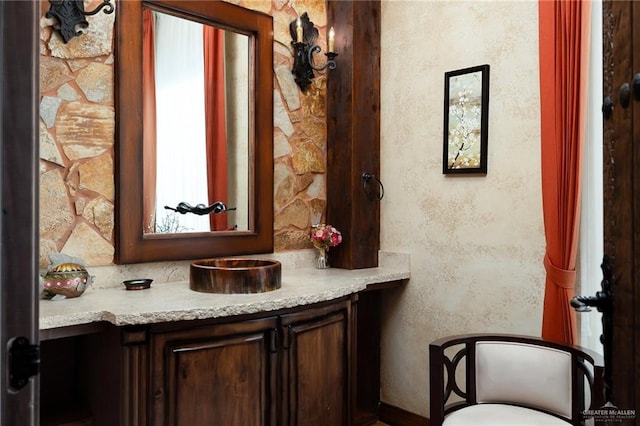 interior space with light stone counters and dark brown cabinets