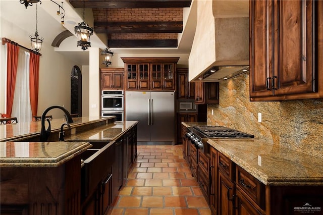 kitchen featuring custom exhaust hood, decorative backsplash, appliances with stainless steel finishes, beamed ceiling, and decorative light fixtures