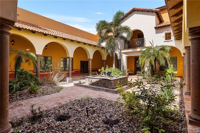 back of house featuring a balcony