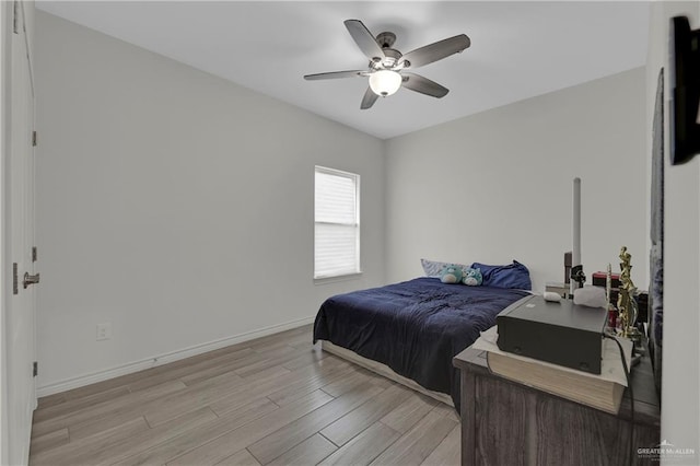 bedroom with light hardwood / wood-style flooring and ceiling fan