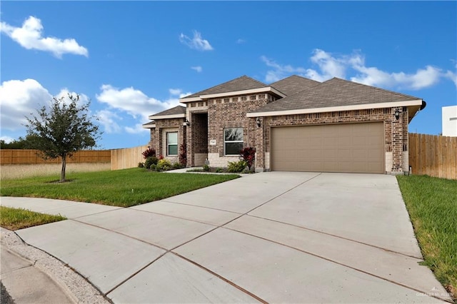 view of front of house featuring a front yard and a garage