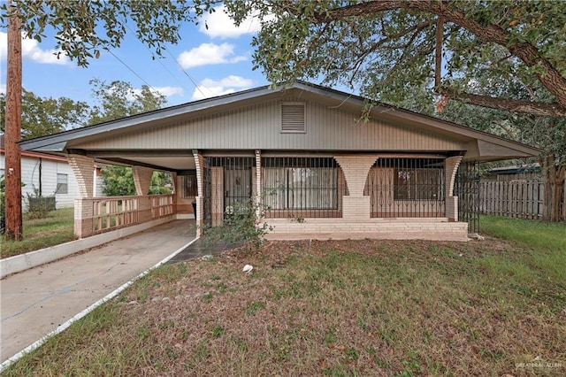 405 S 29th St, Mcallen, TX 78501 - view of front of home with brick siding, fence, concrete driveway, a carport, and a front yard