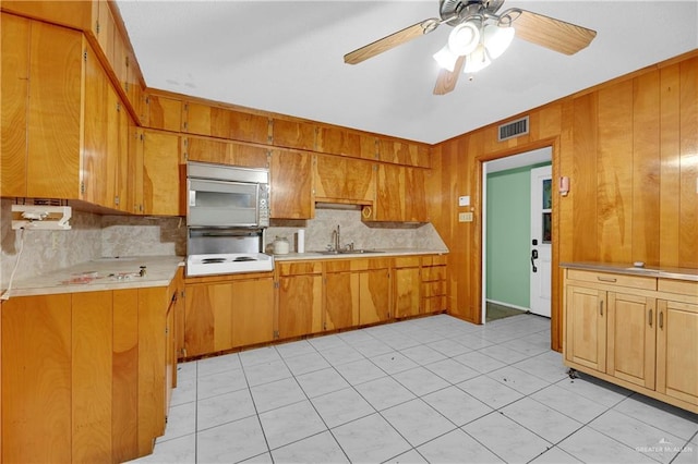 405 S 29th St, Mcallen, TX 78501 - kitchen with a sink, visible vents, light countertops, brown cabinetry, and stainless steel microwave