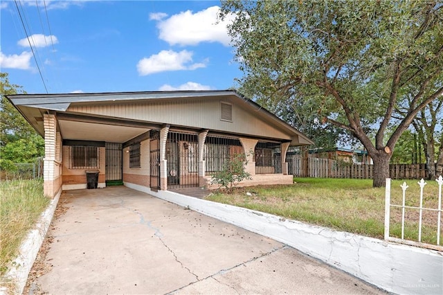 405 S 29th St, Mcallen, TX 78501 - view of front of home with a carport, concrete driveway, brick siding, and a front yard