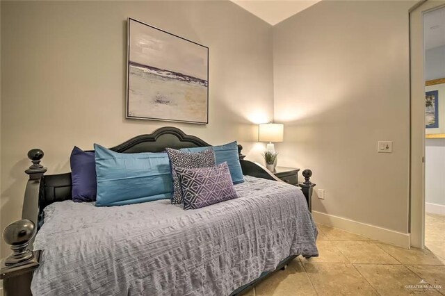 310 Padre Blvd, South Padre Island, TX 78597 - tiled bedroom with baseboards and vaulted ceiling