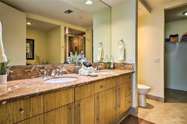 310 Padre Blvd, South Padre Island, TX 78597 - bathroom featuring double vanity, a stall shower, tile patterned floors, recessed lighting, and a walk in closet