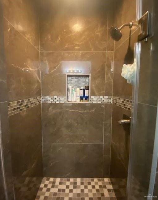 bathroom with a shower with door