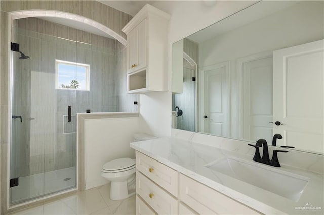 bathroom featuring marble finish floor, toilet, vanity, and a shower stall