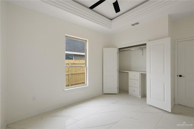 unfurnished bedroom featuring visible vents, a raised ceiling, ceiling fan, marble finish floor, and a closet