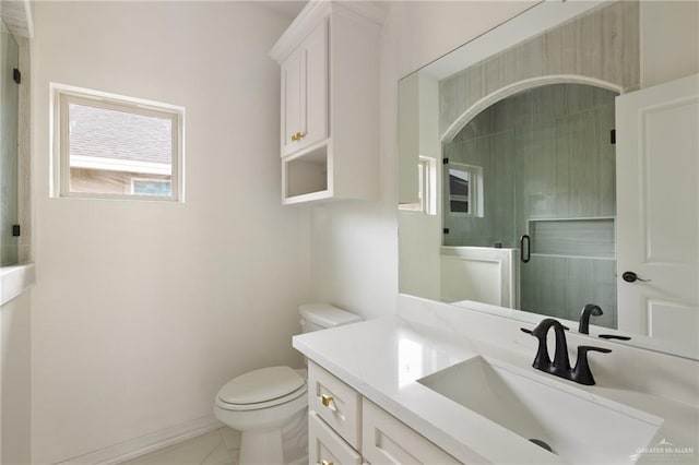 bathroom featuring toilet, vanity, and baseboards