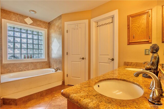 bathroom featuring tile patterned floors, a bathing tub, and vanity