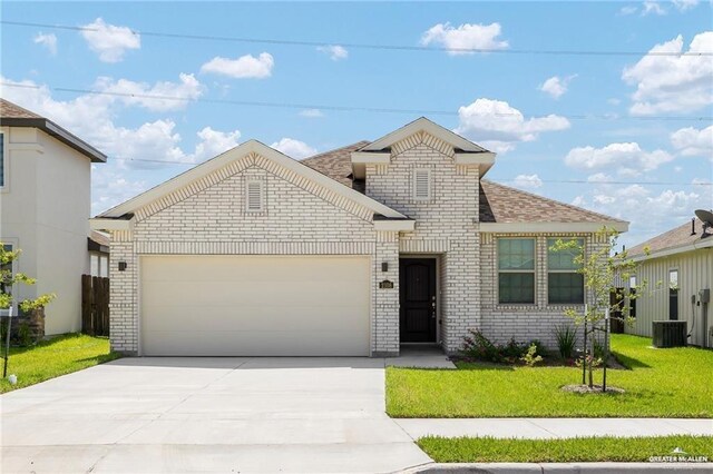 view of property with a garage and a front lawn