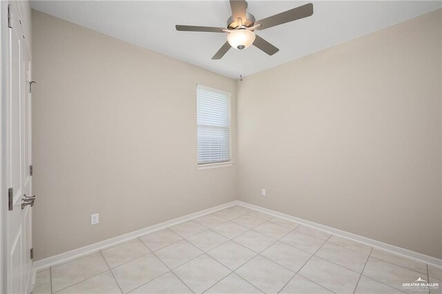 tiled spare room with ceiling fan