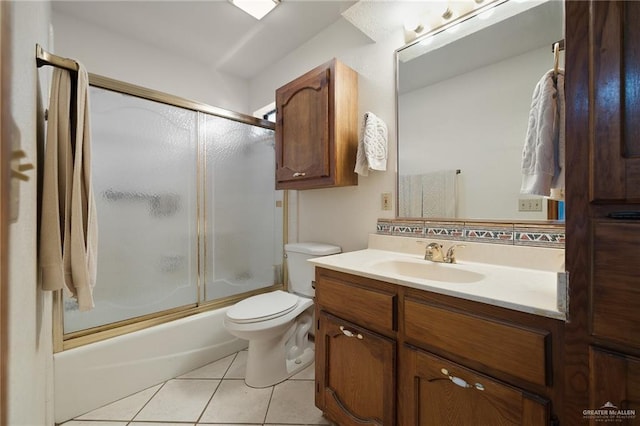 full bathroom featuring tile patterned floors, enclosed tub / shower combo, toilet, and vanity