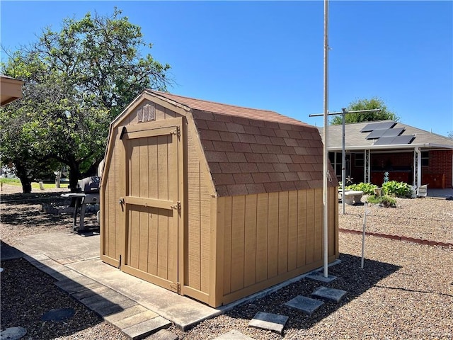 view of shed featuring solar panels