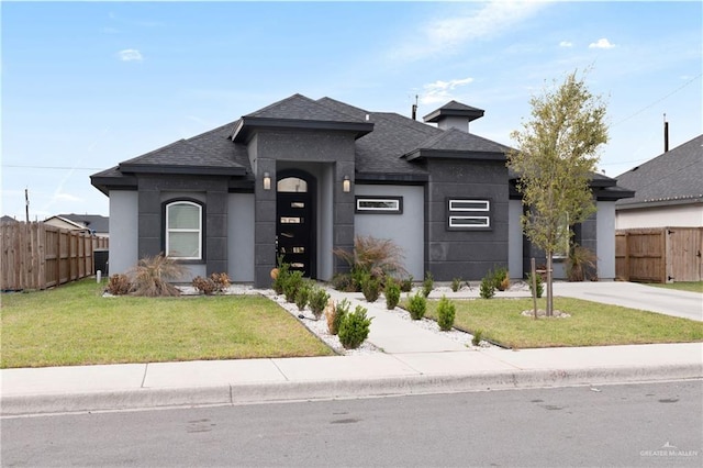 827 Blue Quail St, Alamo, TX 78516 - prairie-style house with a front lawn, fence, roof with shingles, and stucco siding