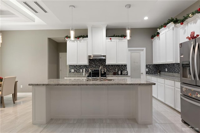 kitchen with visible vents, a kitchen island with sink, a sink, under cabinet range hood, and appliances with stainless steel finishes