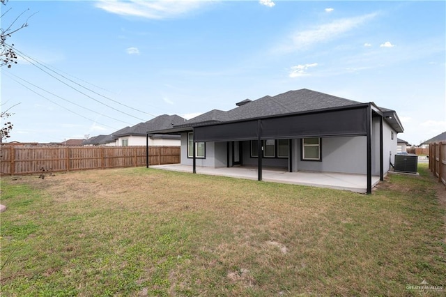 back of house with cooling unit, a yard, a patio, and a fenced backyard