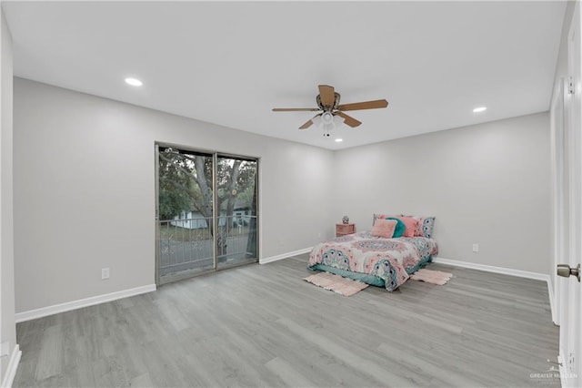 unfurnished bedroom featuring ceiling fan, access to exterior, and light wood-type flooring